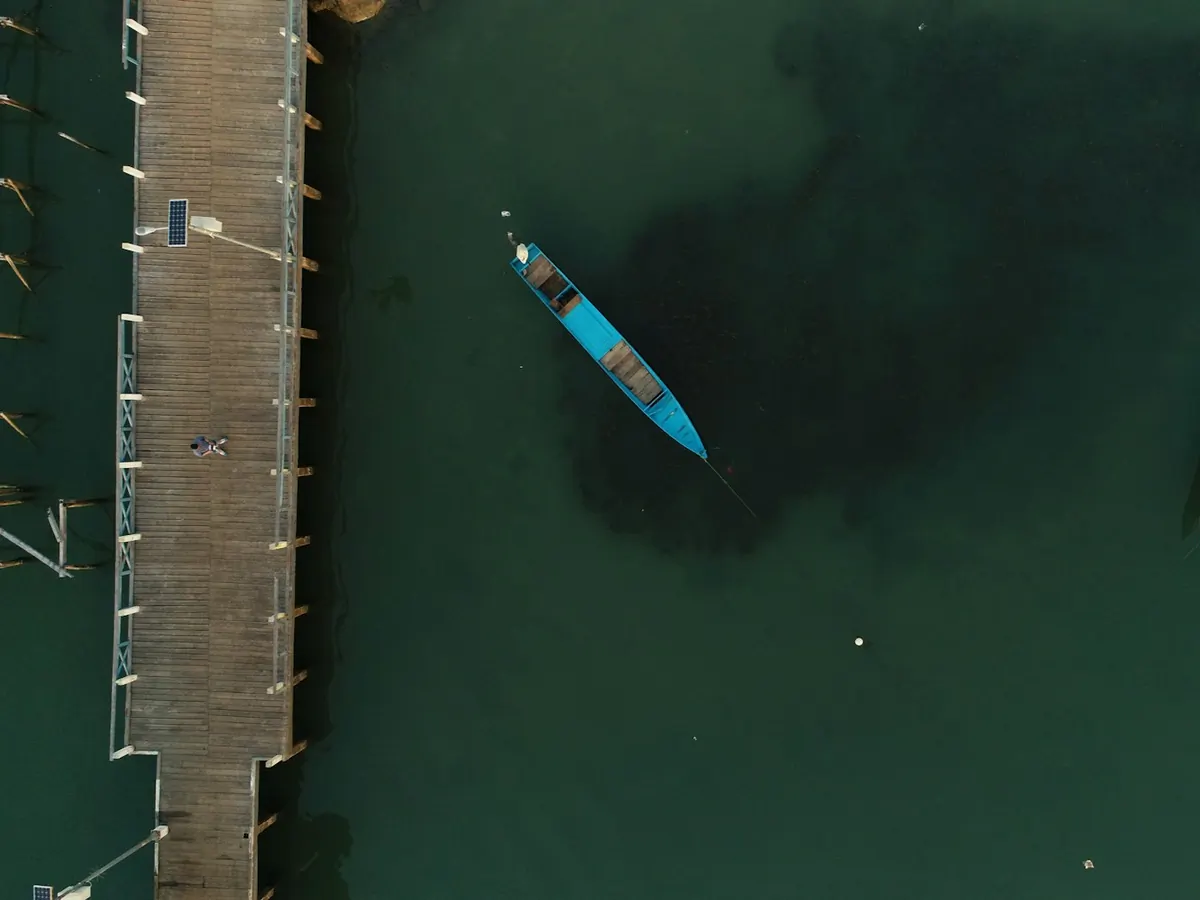 Wooden boat beside a jetty, South Morotai, from the air