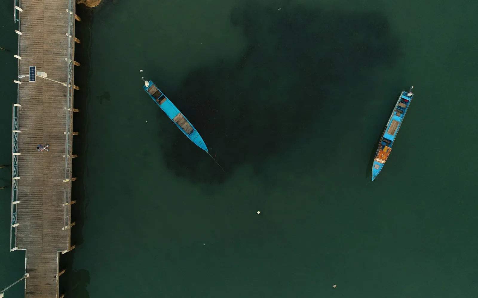 Aerial view of wooden boats beside a jetty, South Morotai