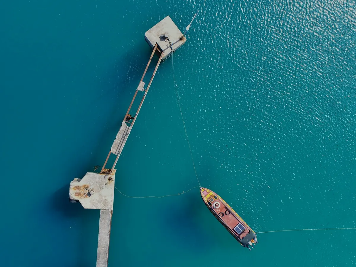 Boat moored near a jetty in clear water, South Morotai