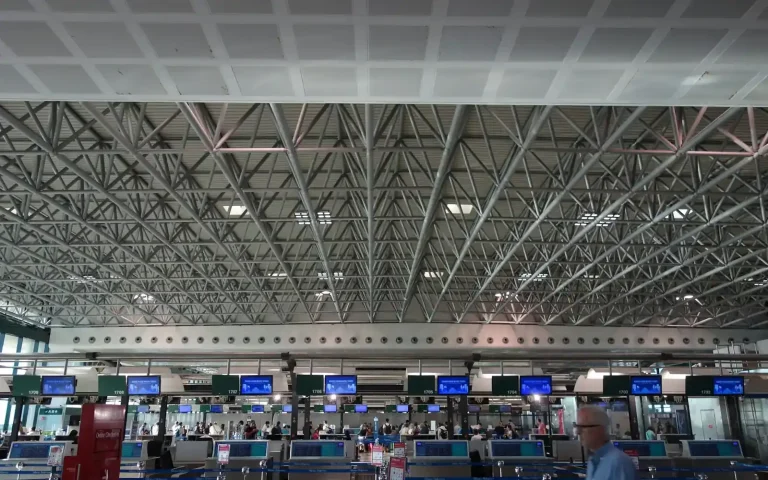 Airport check-in hall with rows of counters