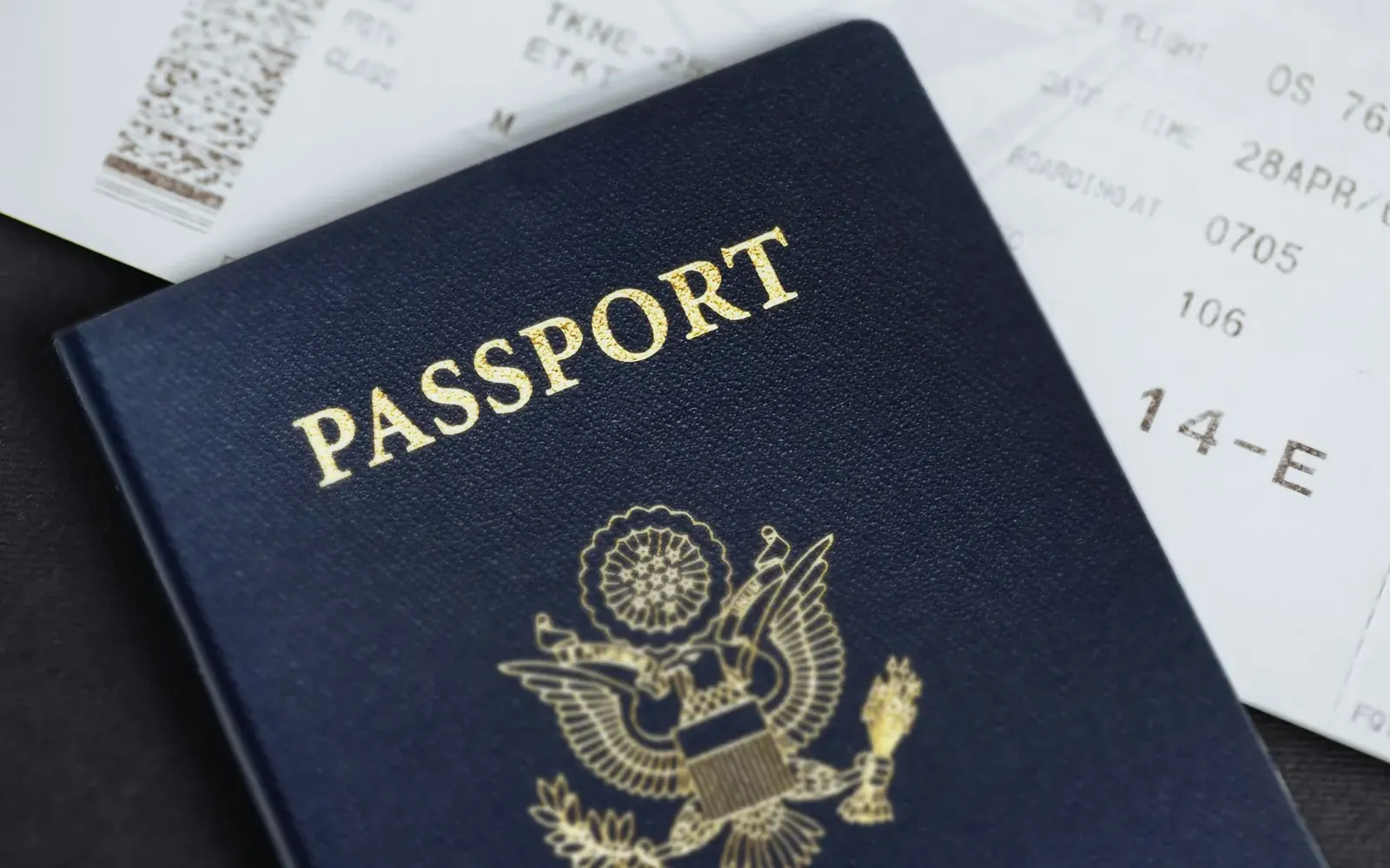 Passport lying on top of a boarding pass