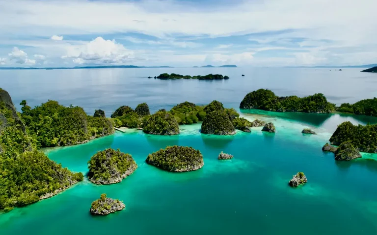 Aerial view of green limestone islands in a turquoise lagoon