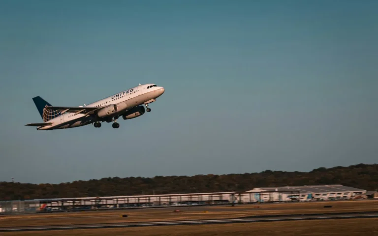 Passenger jet taking off from a runway at dusk