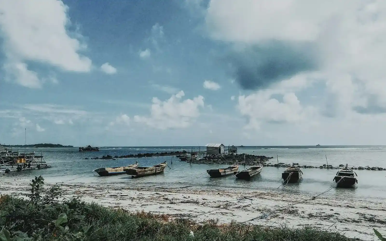 Wooden fishing boats moored on a shallow Indonesian shoreline